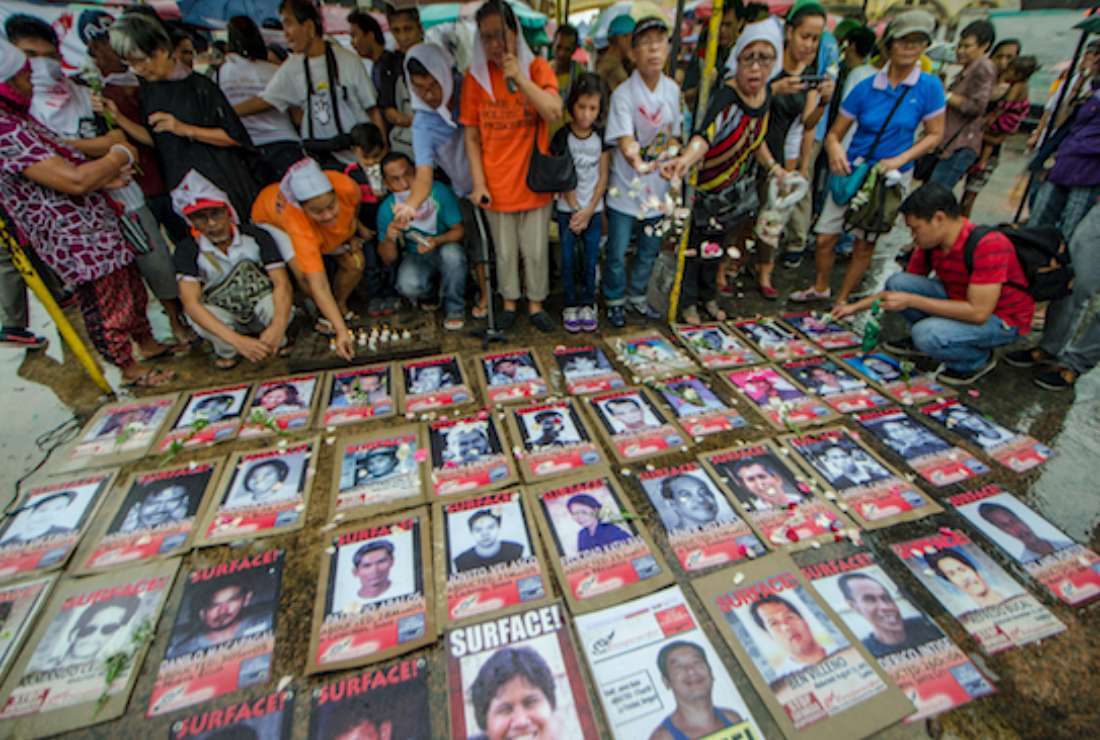 Families of victims of enforced disappearances display photographs of their missing loved ones in Manila on All Souls' Day in 2017