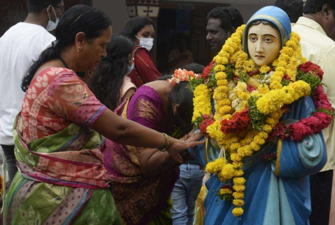Catholic devotees offer prayers at a statue of the Virgin Mary during the annual feast of the Nativity of the Blessed Virgin Mary at the Shrine of Our Lady of Health in Hyderabad on Sept 8, 2022