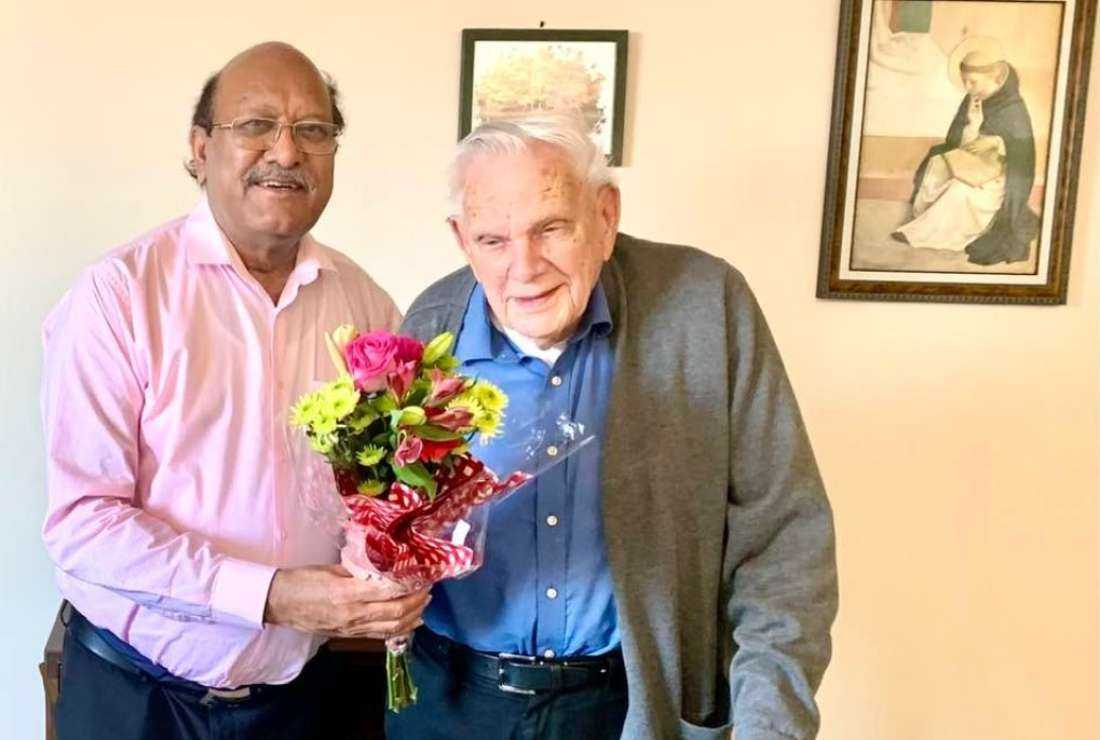 Father James Channan (left), director of the Dominican Peace Center, presents gifts to Bishop Ernest Bertrand Boland of Multan on his 97th birthday in the US