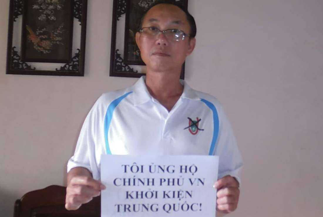 Dang Dang Phuoc with a banner asking Vietnam to sue China for marine invasion before his arrest in September 2022