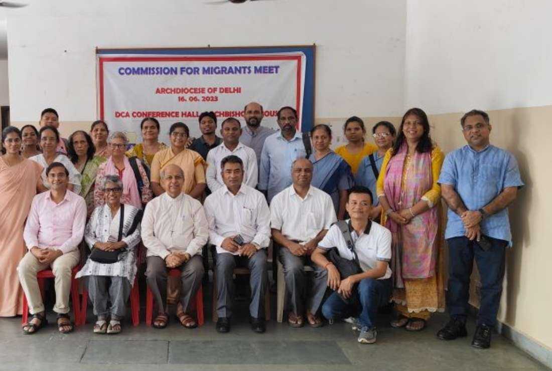 Archbishop Anil Joseph Couto of Delhi (seated third from left) poses for a group photo at a workshop of migrants in New Delhi on June 16