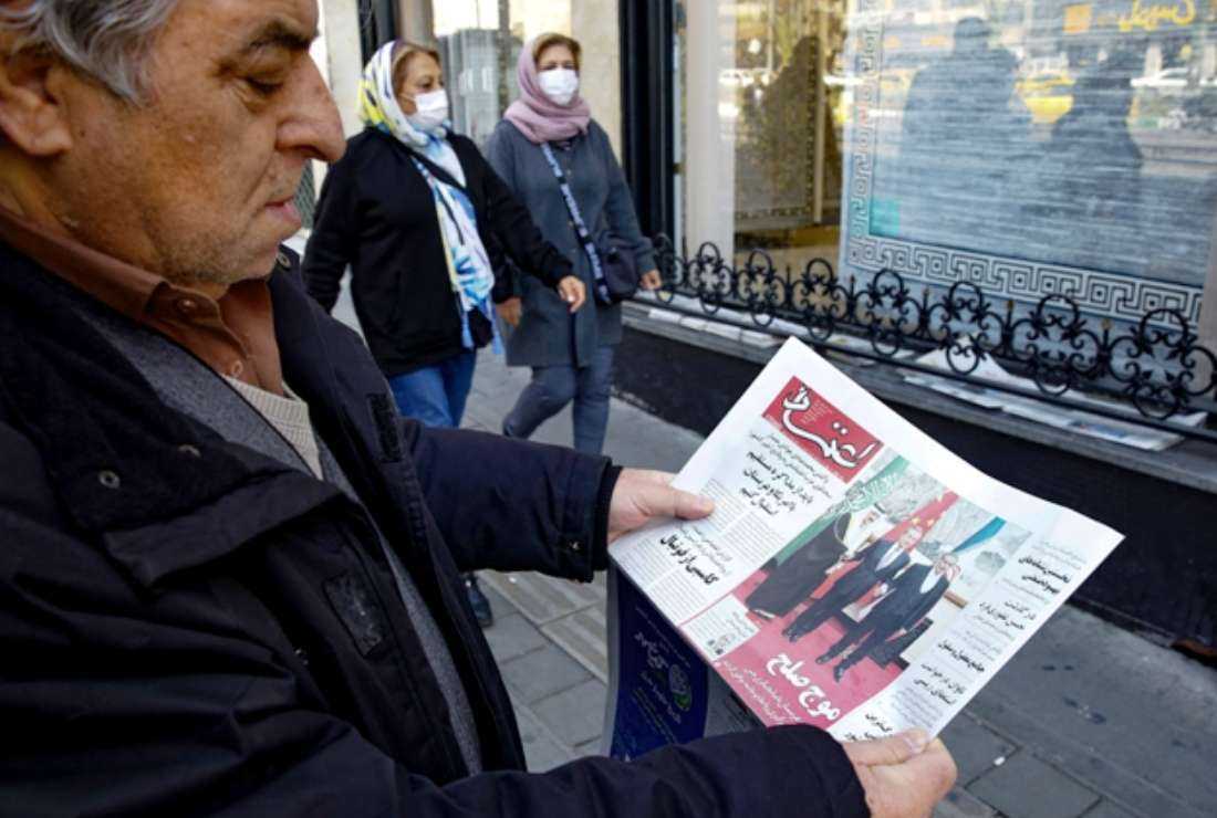 A man in Tehran holds a local newspaper reporting on its front page the China-brokered deal between Iran and Saudi Arabia to restore ties, signed in Beijing the previous day, on March 11. Riyadh and Tehran announced on March 10 that after seven years of severed ties, they would reopen embassies and missions within two months and implement security and economic cooperation agreements signed more than 20 years ago