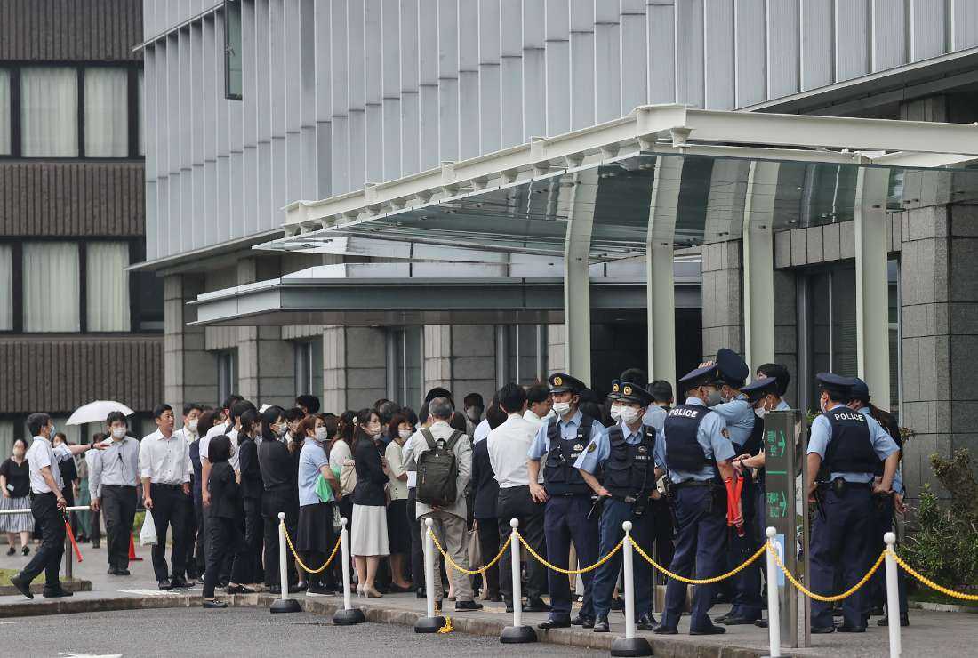 Staff members stand outside the Nara District Court after temporarily evacuating from the building after a suspicious object was delivered during the pre-trial hearing for Tetsuya Yamagami, the man accused of killing Japan's former prime minister Shinzo Abe, in Nara on June 12
