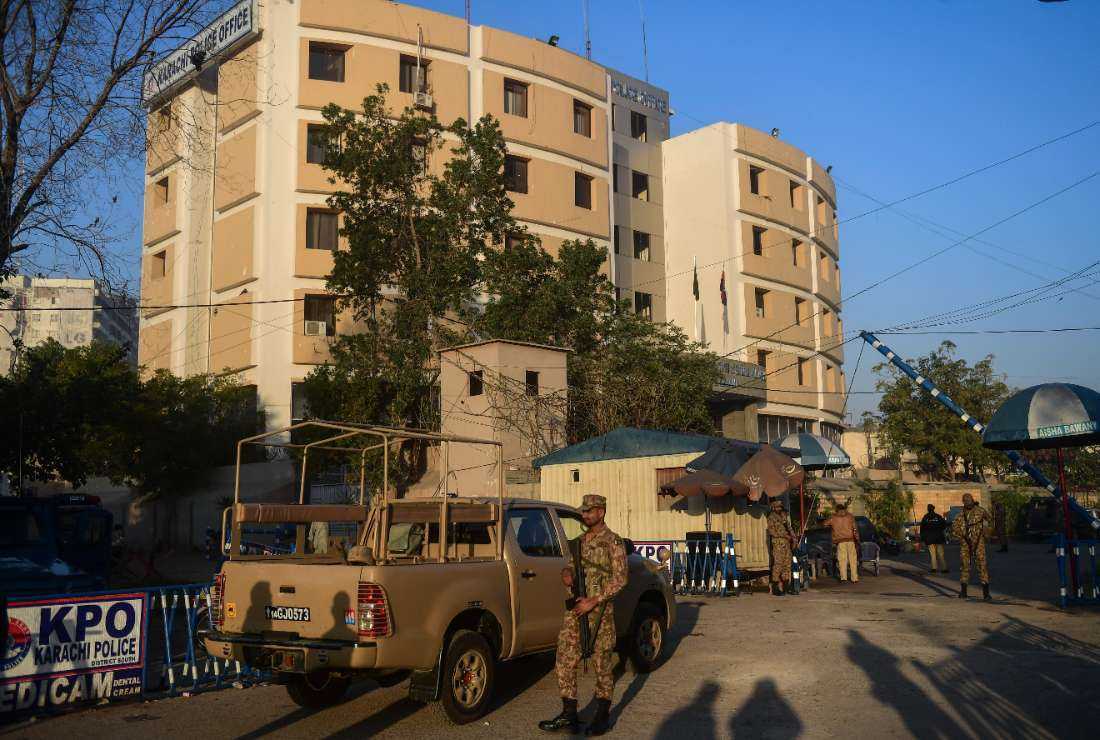 Pakistani army soldiers stand guard outside the Karachi Police Office compound a day after an attack by Pakistan's Taliban in Karachi on Feb. 18