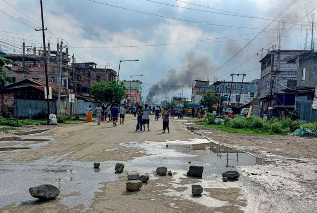 Smoke billows from a street after a standoff between mob and security forces at Sekhon in Imphal East during ongoing ethnic violence in India's north-eastern Manipur state on June 15