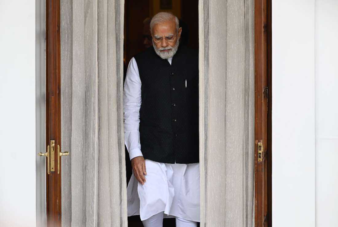 Indian Prime Minister Narendra Modi walks to receive Nepal Prime Minister Pushpa Kamal Dahal (not pictured) before their meeting at Hyderabad House in New Delhi on June 1